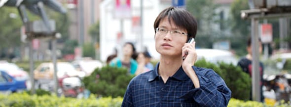 Mobile phone user in the central shopping district of Shanghai, China