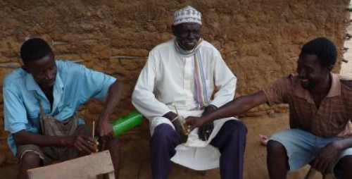 Three of Samuel’s customers enjoying a bottle of Mnazi