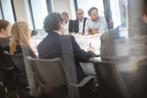 A group of people sitting around a table.
