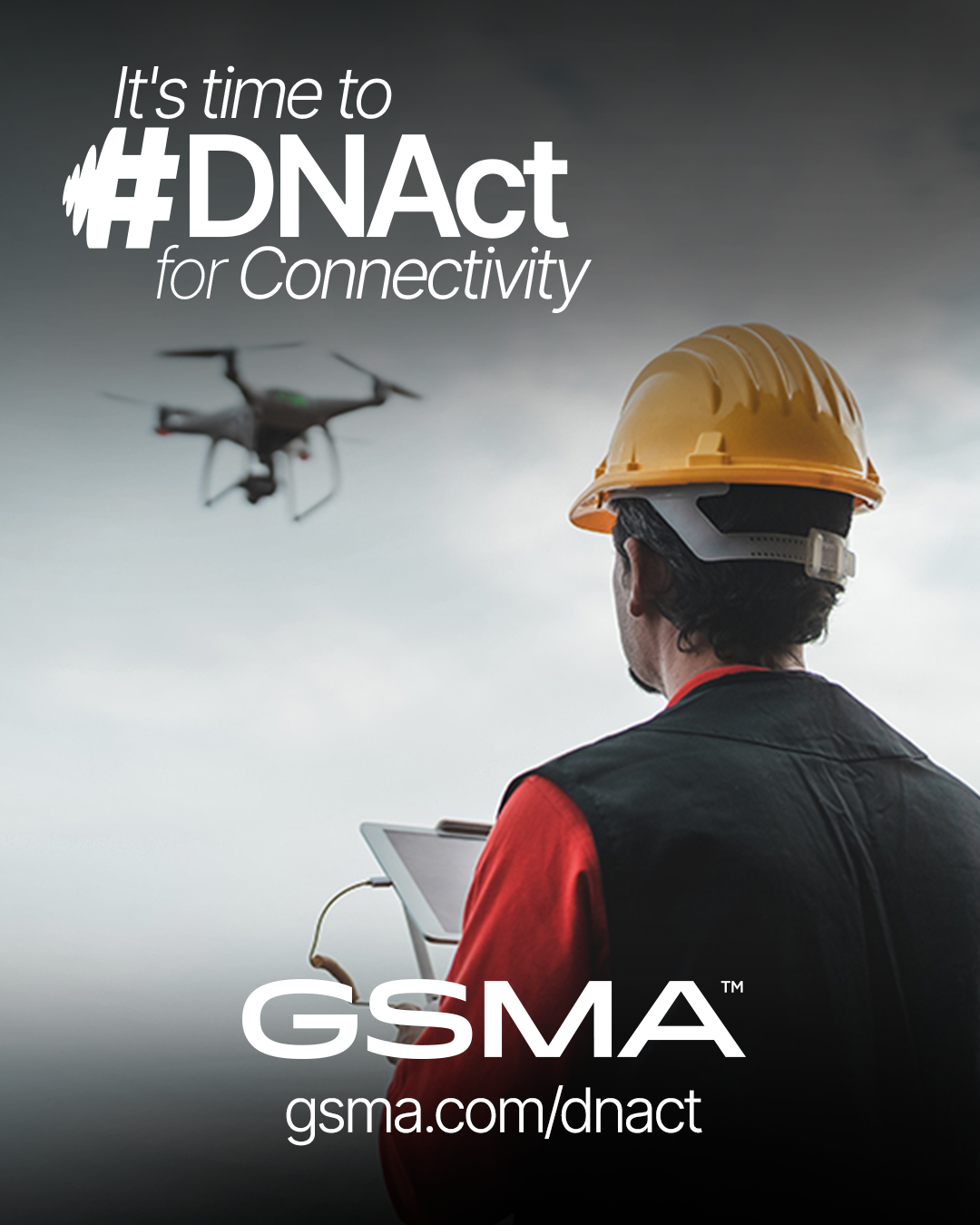 A person in a hard hat and safety vest holds a clipboard, facing a hovering drone in a cloudy sky. Text reads, “It’s time to #DNAct for Connectivity. GSMA gsma.com/dnact.”.