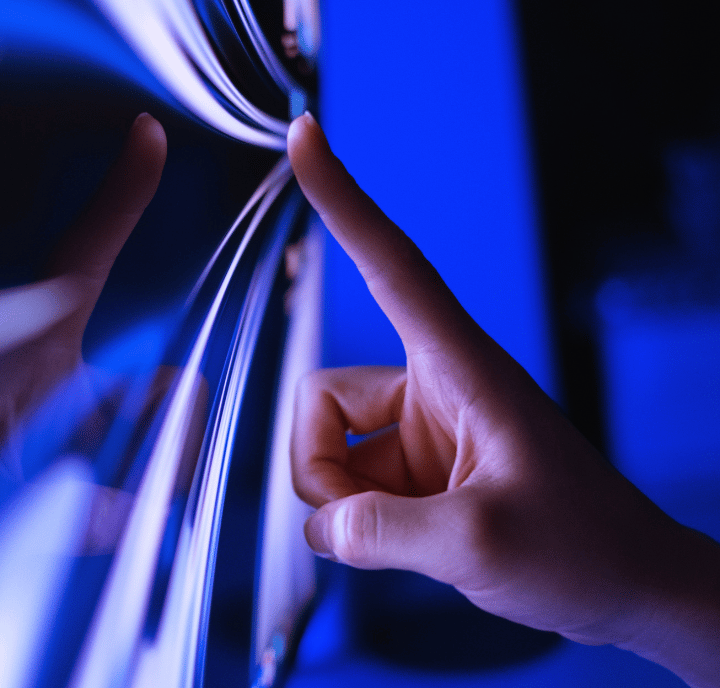 A finger touches a blue screen