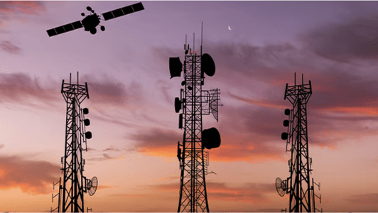 Three telecom masts at sunset with a satellite flying overhead in the colourful sky, highlighting the innovations driven by the GSMA regional interest group.