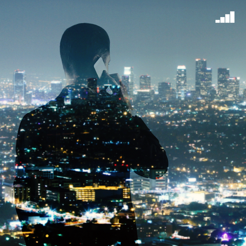 A silhouette of a man superimposed over a nighttime city skyline, symbolizing contemplation or managing the urban spectrum.
