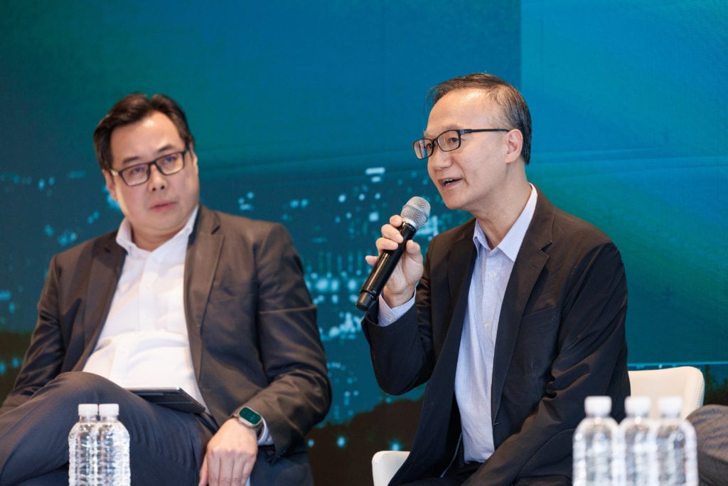 A panellist speaking on stage.