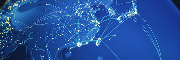 A digital map of Earth showing glowing network connections between continents on a blue background.