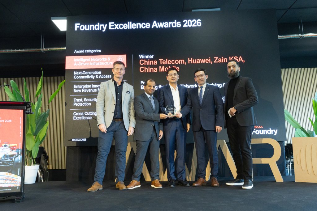 Five men in suits stand onstage holding an award at the Foundry Excellence Awards 2026 event.