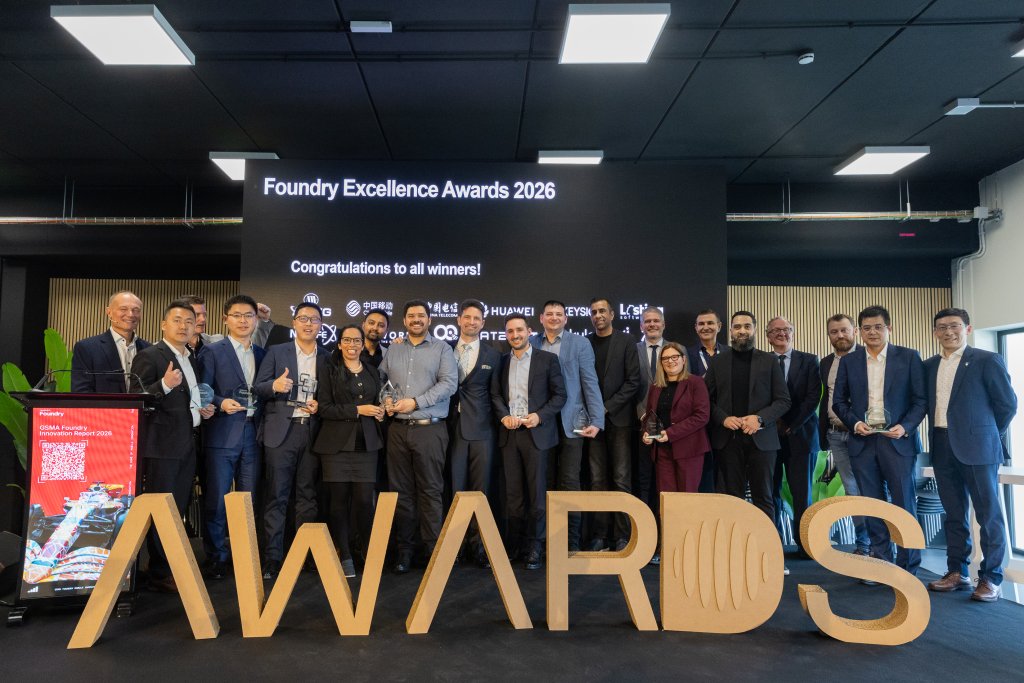 A group of people in business attire pose with trophies at the Foundry Excellence Awards 2026.