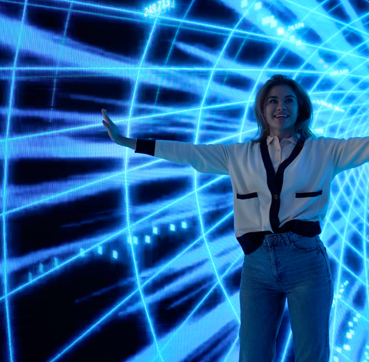 A woman standing in front of a blue light tunnel with GSMA membership.