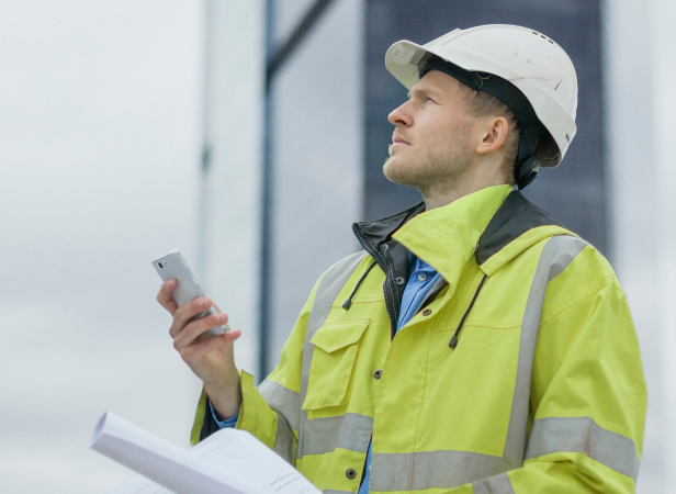 man in helmet using a mobile phone