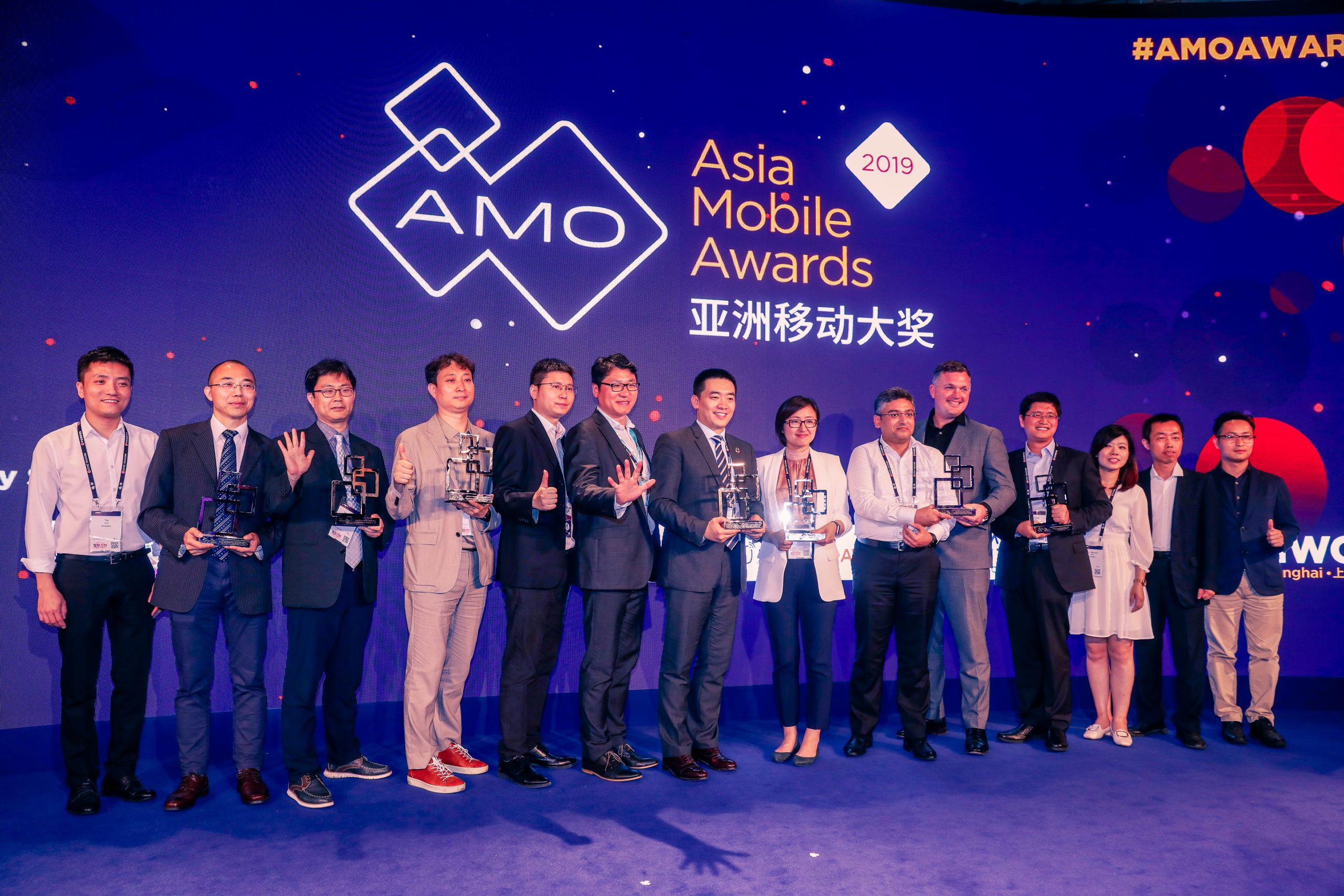 14 people on stage celebrating after winning separate Asia Mobile Awards in 2019