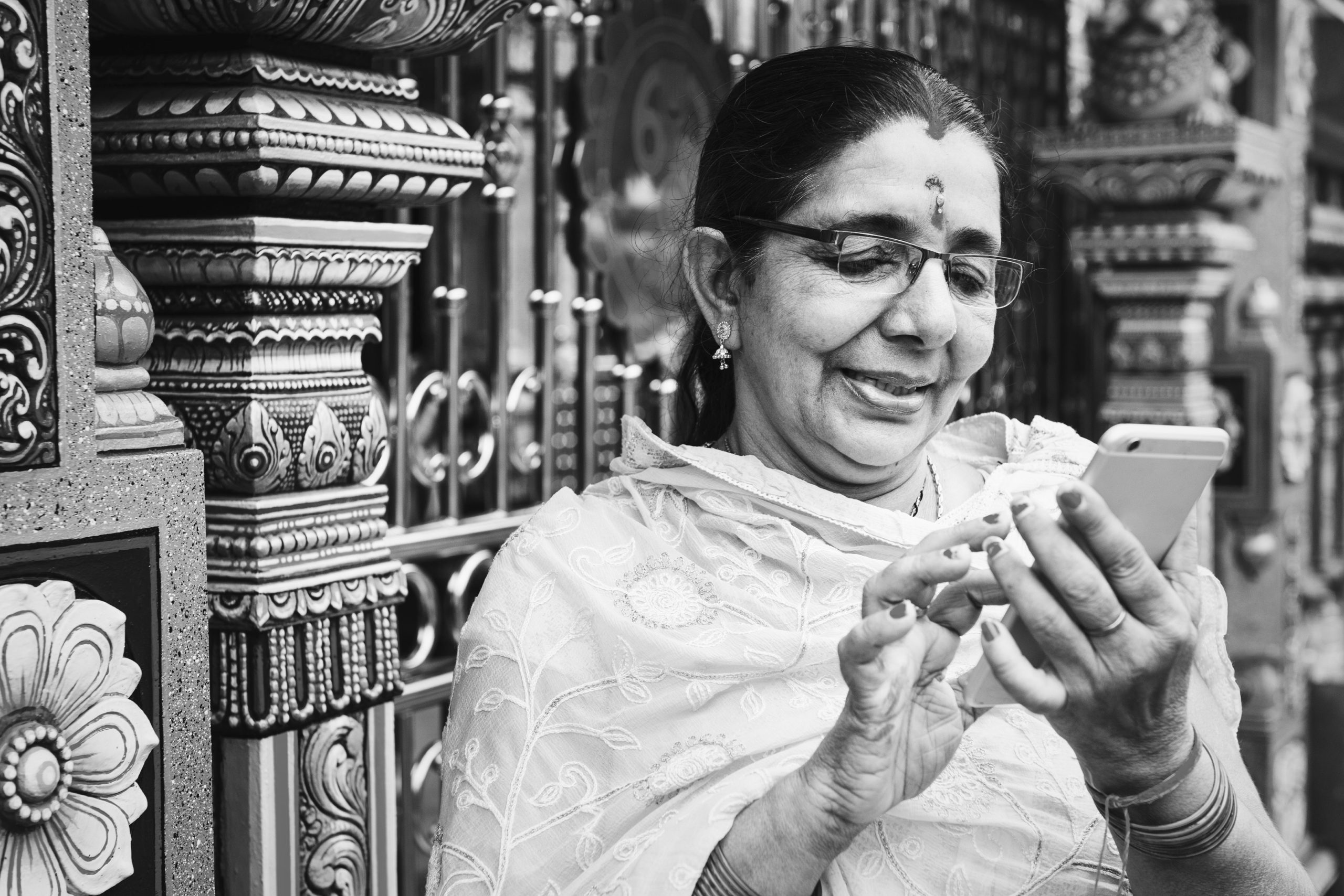 Woman from India, using her phone