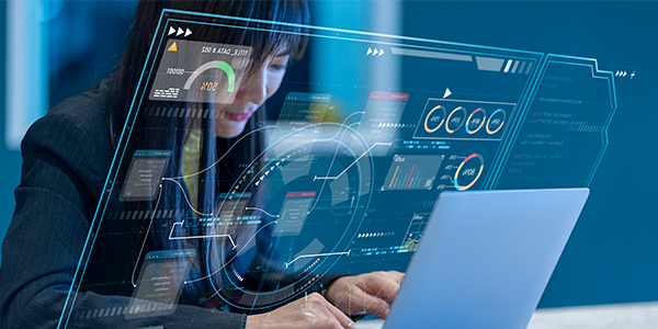 A woman types on a laptop, overlaid with translucent futuristic interface graphics showing charts, data, graphs, and digital dashboards, suggesting advanced data analysis or technology work in a modern, professional setting.