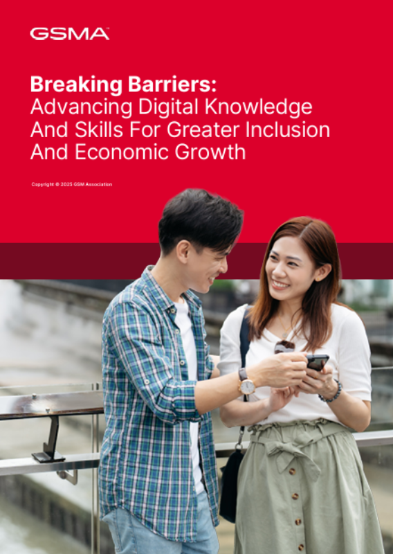 A young man and woman stand outside, smiling and looking at a mobile phone together. The background is urban with a railing and blurred buildings. Above them is a red banner with white and pink text about advancing digital knowledge for inclusion and economic growth.