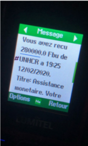 A phone screen, with text in French indicating that a cash transfer was received.