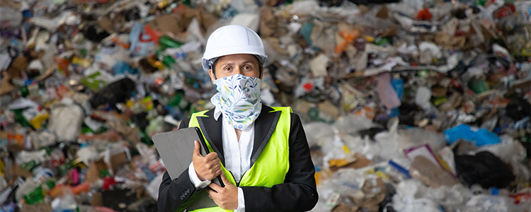 Woman stands in front of plastic waste