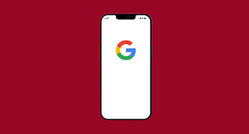 Smartphone displaying google logo on screen against a red background.