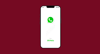 Smartphone displaying the whatsapp application start-up screen on a maroon background.
