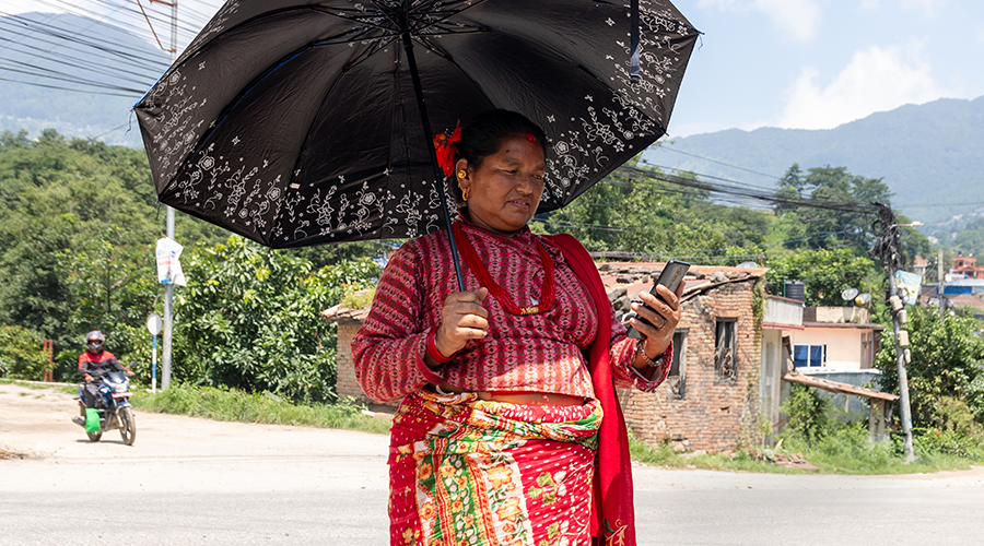 Photo of a South Asian woman looking at her mobile phone