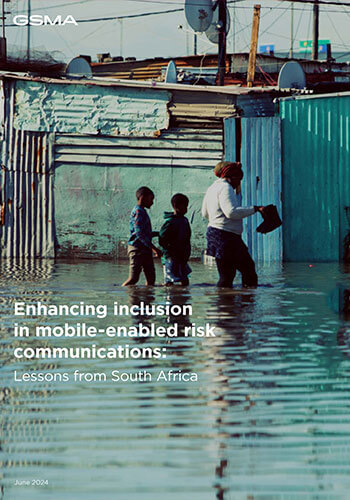 A woman and two children wade through ankle-deep floodwater past metal shacks in an informal settlement. Reflections shimmer in the water. Text: “Enhancing inclusion in mobile-enabled risk communications: Lessons from Tanzania's mobile-enabled early warning systems.”.