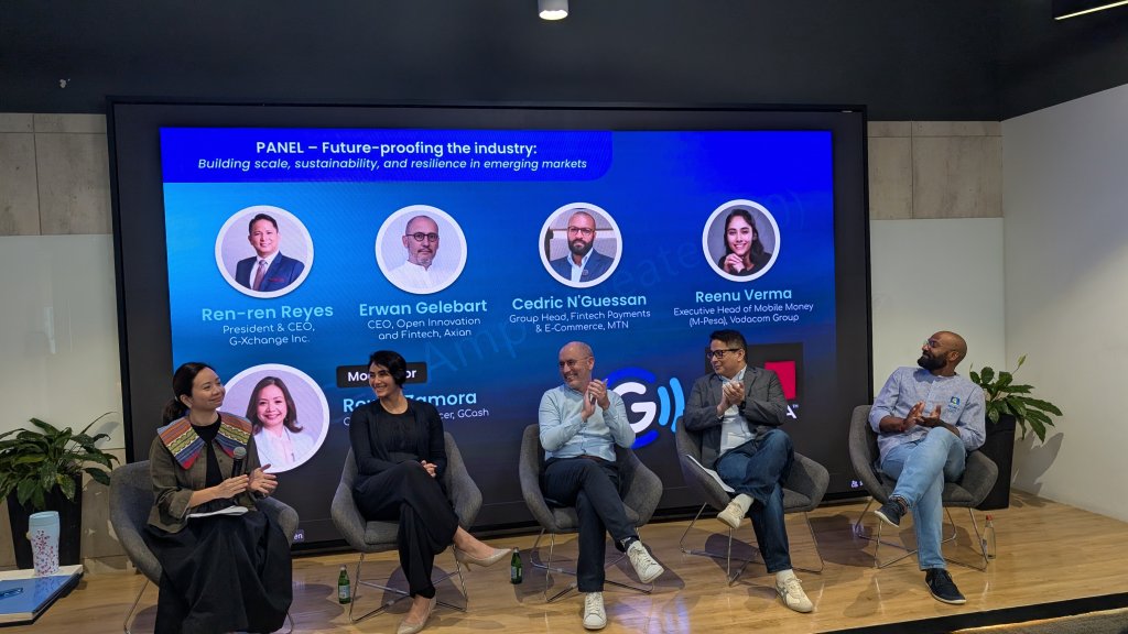 Five panelists are seated in front of a large screen displaying their names and titles. The panel discussion topic is "Future-proofing the industry." All are engaged in conversation, with some holding microphones. The setting is a modern conference or event space.