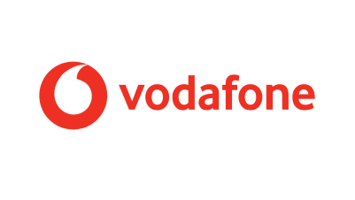 The image shows the Vodafone logo, featuring a red, circular icon with a white center resembling a quotation mark, to the left of "vodafone" in lowercase red letters—reflecting the brand’s commitment to mobile-enabled early warning systems.
