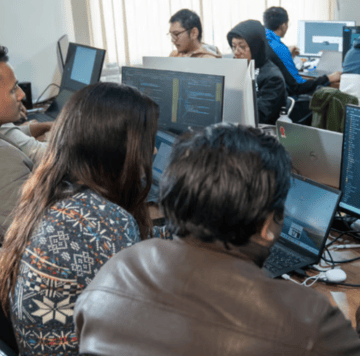 People working on computers in an office environment.