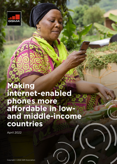 A woman in colourful clothing sits outdoors, holding a mobile phone and smiling. She is surrounded by fresh produce in baskets. The text reads: “Handset Affordability: Making internet-enabled phones more affordable in low- and middle-income countries. April 2022. GSMA.”.