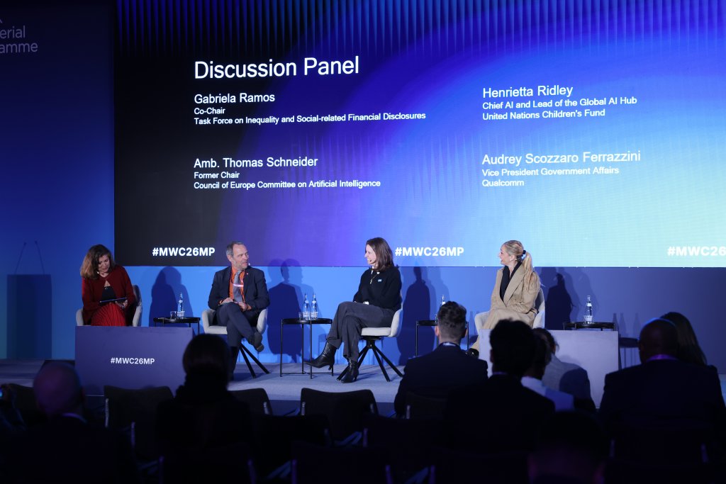 Four panelists sit on stage at the conference, discussing AI and financial disclosures while sharing Ministerial Programme 2026 takeaways.