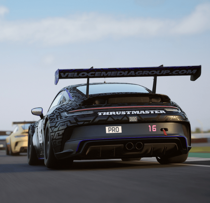 A black race car with a "PRO 16" plate and rear wing speeds down the racetrack, leading another car—perfect for showcasing your statement of requirements in high-performance racing visuals.