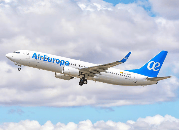 An Air Europa airplane in flight against a cloudy sky.