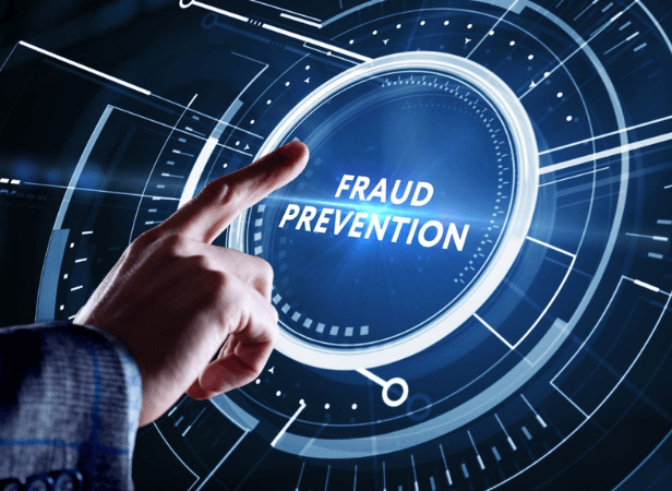 A hand points toward a glowing digital interface displaying the words "FRAUD PREVENTION" in the center, surrounded by circular lines and futuristic blue graphics, symbolizing cybersecurity and advanced technology solutions.