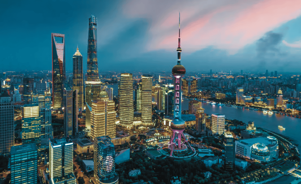 A vibrant cityscape of Shanghai at dusk showcases illuminated skyscrapers like the Shanghai Tower and World Financial Center, with the Huangpu River winding through—a glowing metropolis seamlessly connected like Network APIs under a colorful sky.