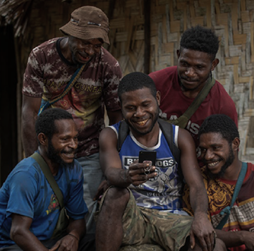 A group of men in a hut.