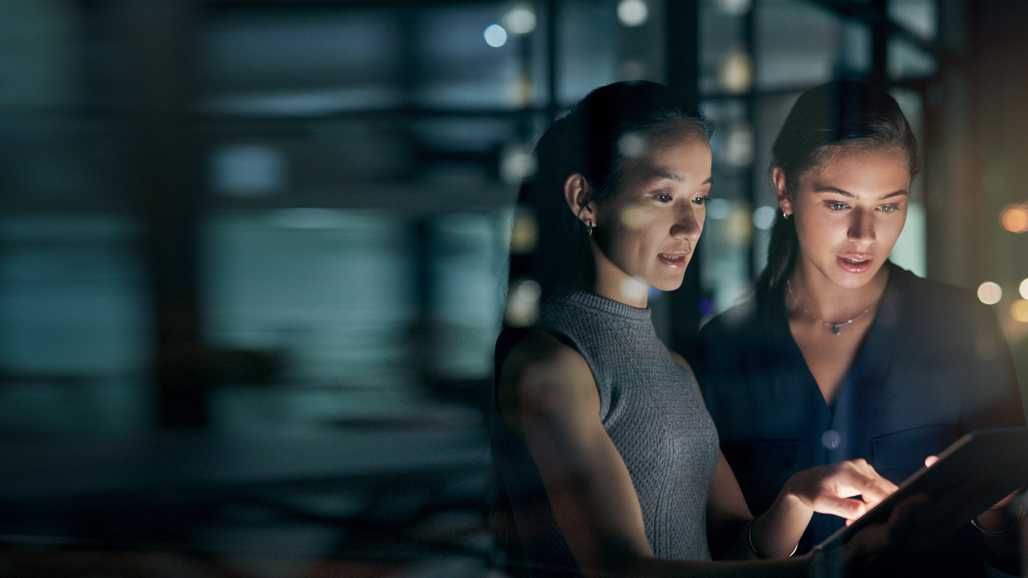 Two business women looking at a tablet 