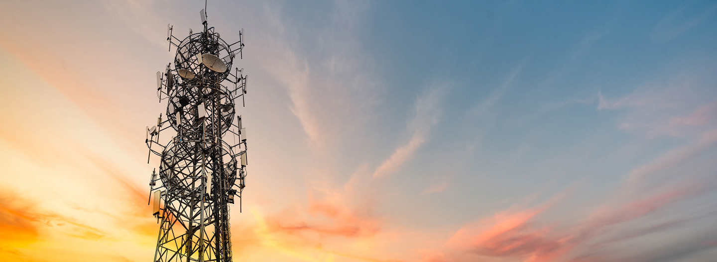 Network equipment tower against a sunset