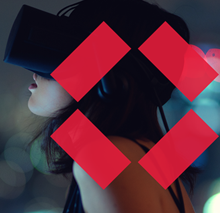 A person wearing a VR headset appears against a blurred background of city lights. Four red, diamond-shaped graphics are overlaid on the image. The person’s face is mostly obscured by the headset, and their hair is visible.