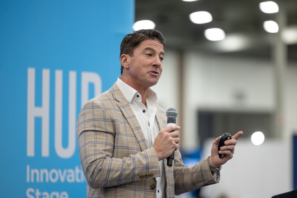 A speaker address the audience on stage