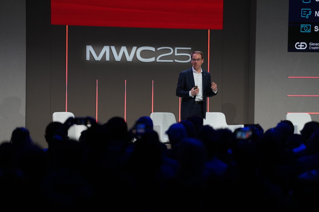 One man on stage talking to an audience of people