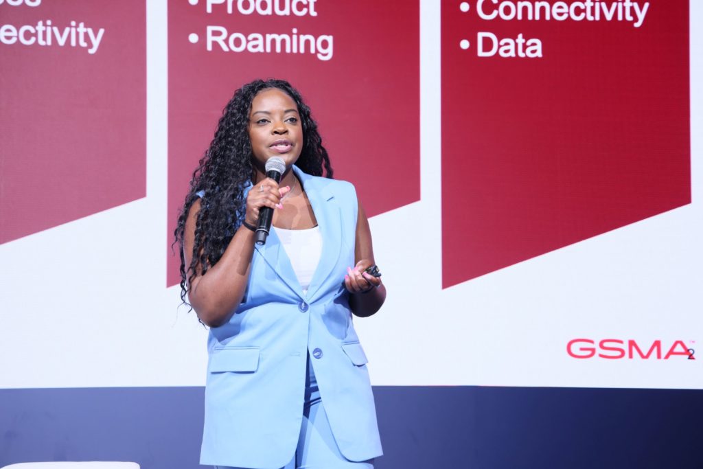 A woman standing on stage speaking