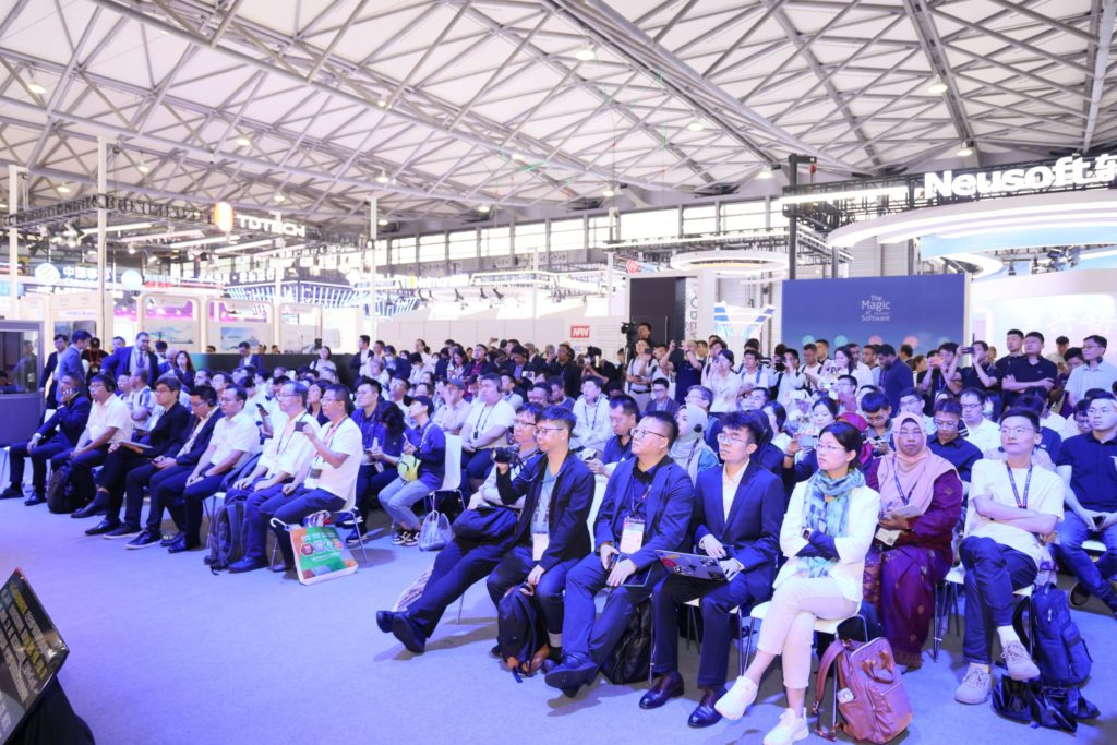 A room full of people sitting down