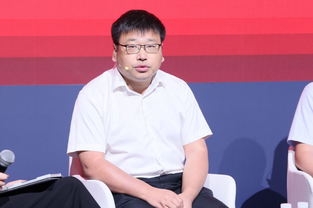 A man sitting on stage talking