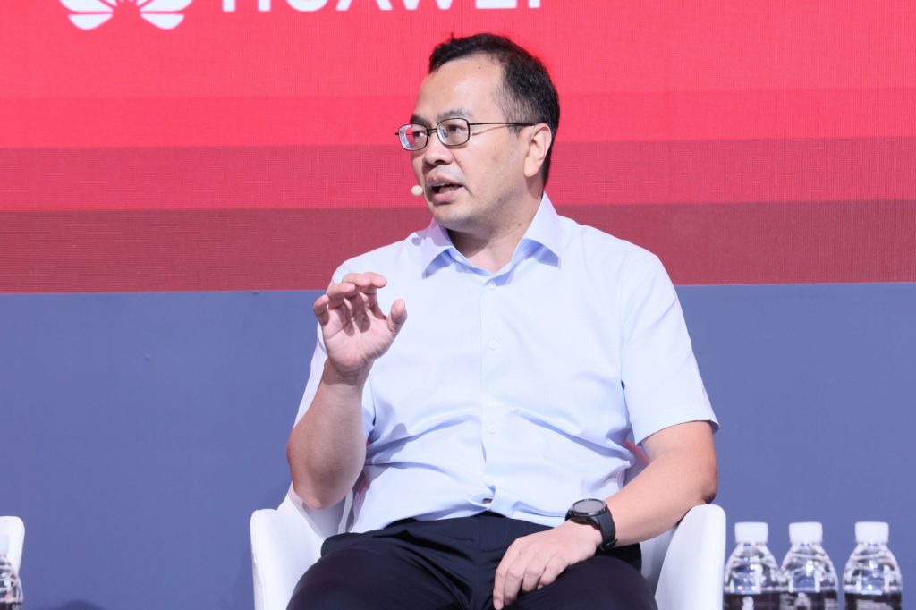 A man sitting on stage speaking