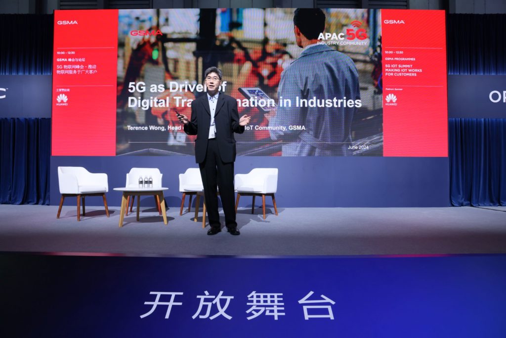 A man standing on stage speaking