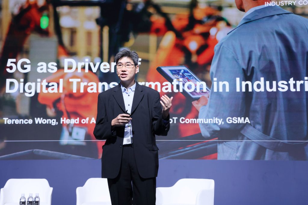 A man standing on stage talking