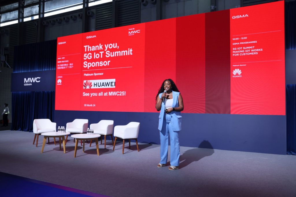 A woman standing on stage speaking