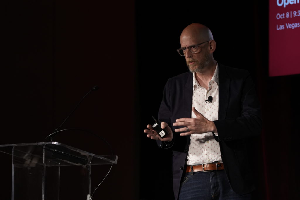 Man on stage speaking