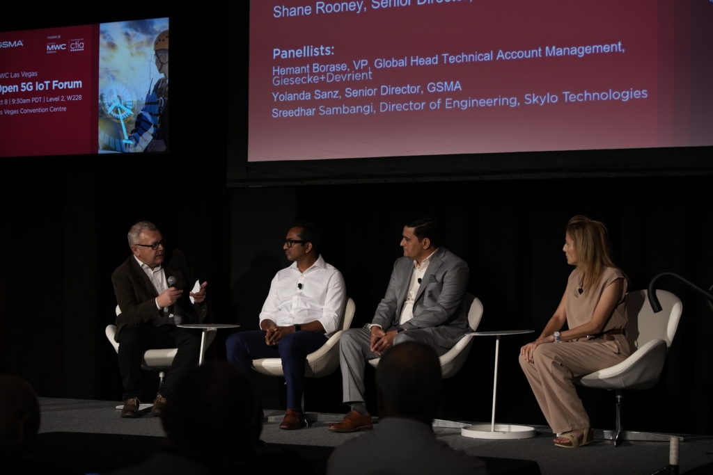 A group of people on stage having a panel discussion