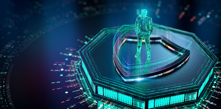 A glowing digital hologram of a human figure stands on a large 3D shield icon, surrounded by futuristic circuitry and data points, symbolizing cybersecurity and digital protection. The color scheme is mainly blue and teal, with neon lighting effects.
