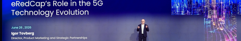 A man in a suit stands on stage before a blue screen displaying “eRedCap’s Role in the 5G Technology Evolution,” event date, his name (Igor Tovberg), title, and a cityscape image with blue lights.