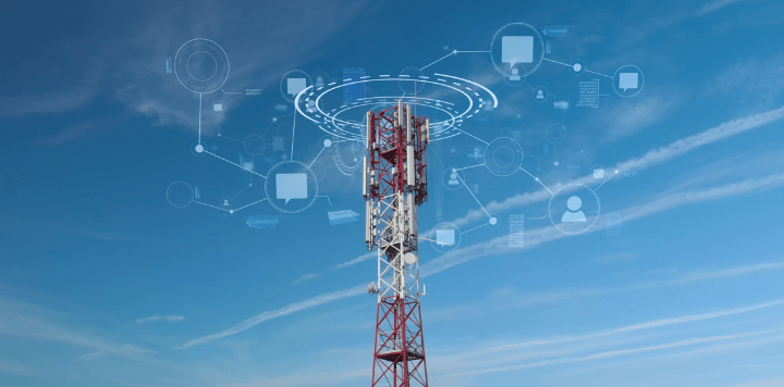 A tall red and white communication tower stands against a blue sky. Digital network icons, such as laptops and user symbols, are superimposed above the tower, illustrating concepts of wireless communication and connectivity. White clouds streak across the sky.
